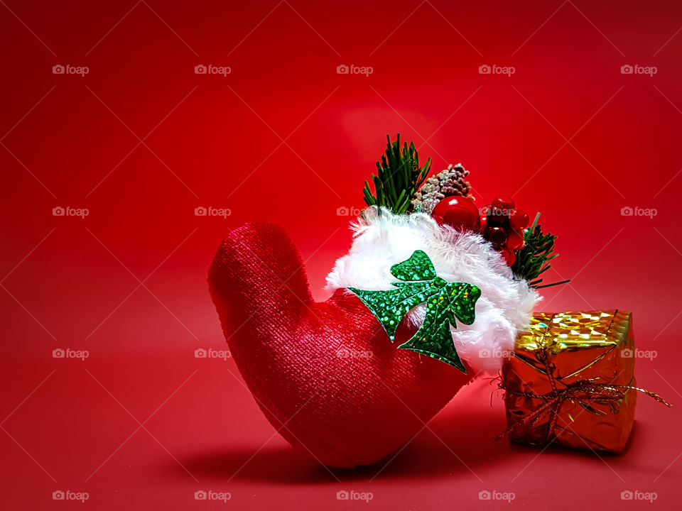 Christmas stocking on red background.