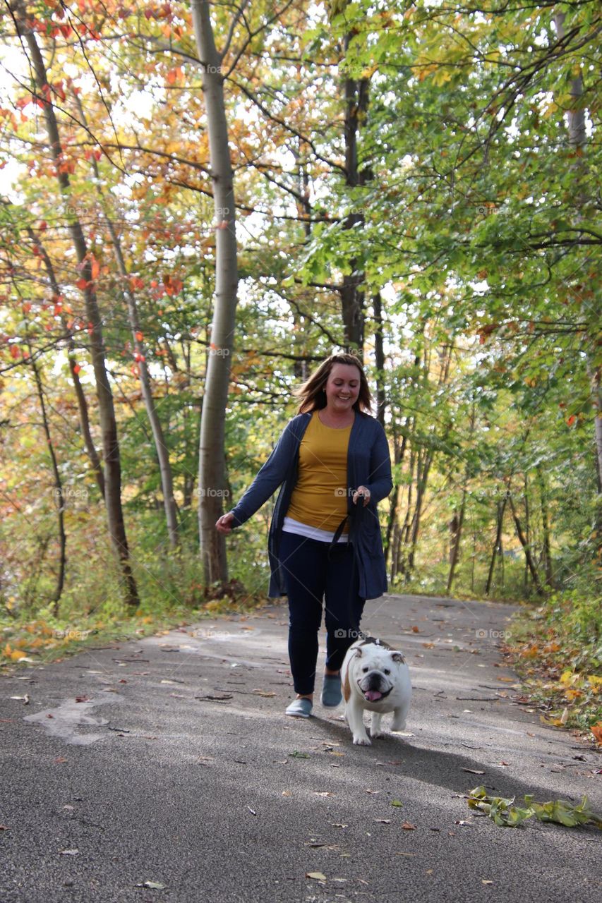 Woman walking her bulldog