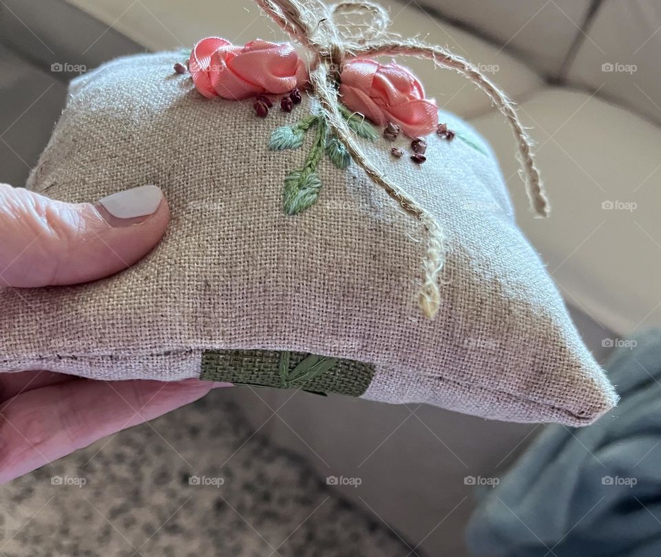 Side view of hand-stitched ring bearer’s pillow. 