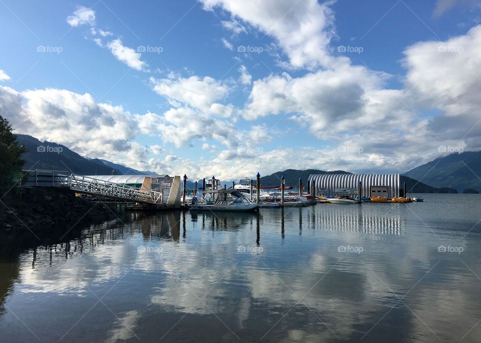 Lake, marina, boathouse, reflection, resort, Harrison hot springs, recreation, watersports, water sports, outdoors, travel, lake, tourism, summer holiday, reflections, mountains, west coast, Canada, British Columbia, Harrison lake, sunny, puffy clouds, bright, image, shaecooke, waters edge, coastline, freshwater, remote, country, nature, vacation