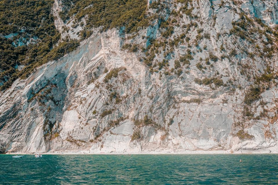 blue water and white cliffs surrounded by trees