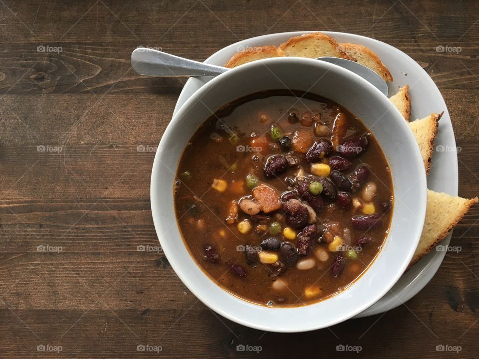 Fall winter soup dish - chili with black beans, ground beef, corn, peas, carrots, peppers, and onions. Cumin, chili, garlic, salt and pepper. Really yummy and good protein. Sided with some toast of course. 