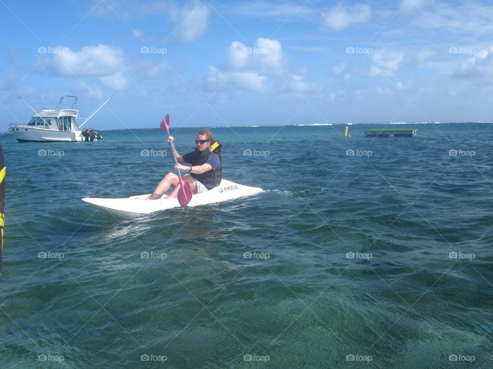 My son on a paddle board in  Mauritius