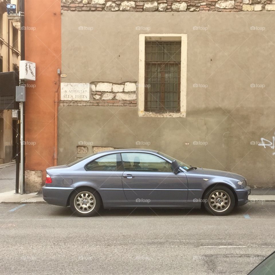 Blue bmw coupe parked on street with nobody around