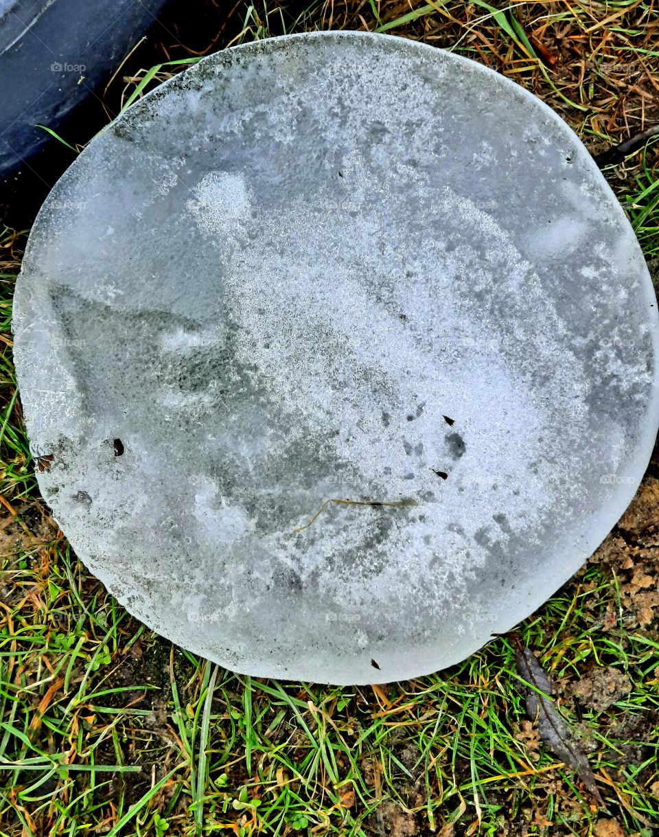 circular shape of a block of ice out of water container