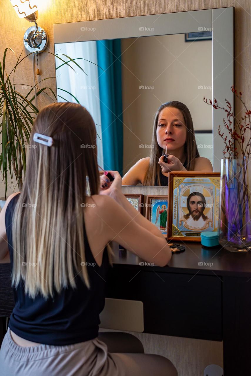 Woman painting lipstick 