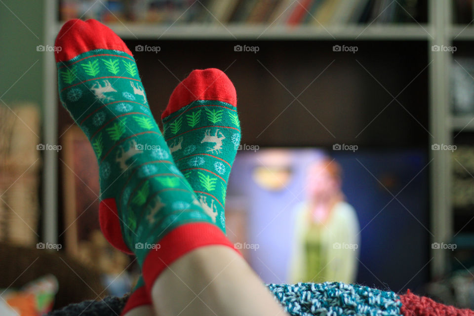 Green Christmas socks, watching tv at home