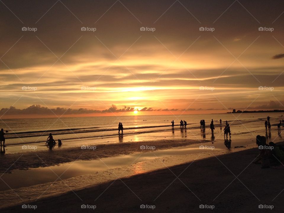 Beach goers at sunset