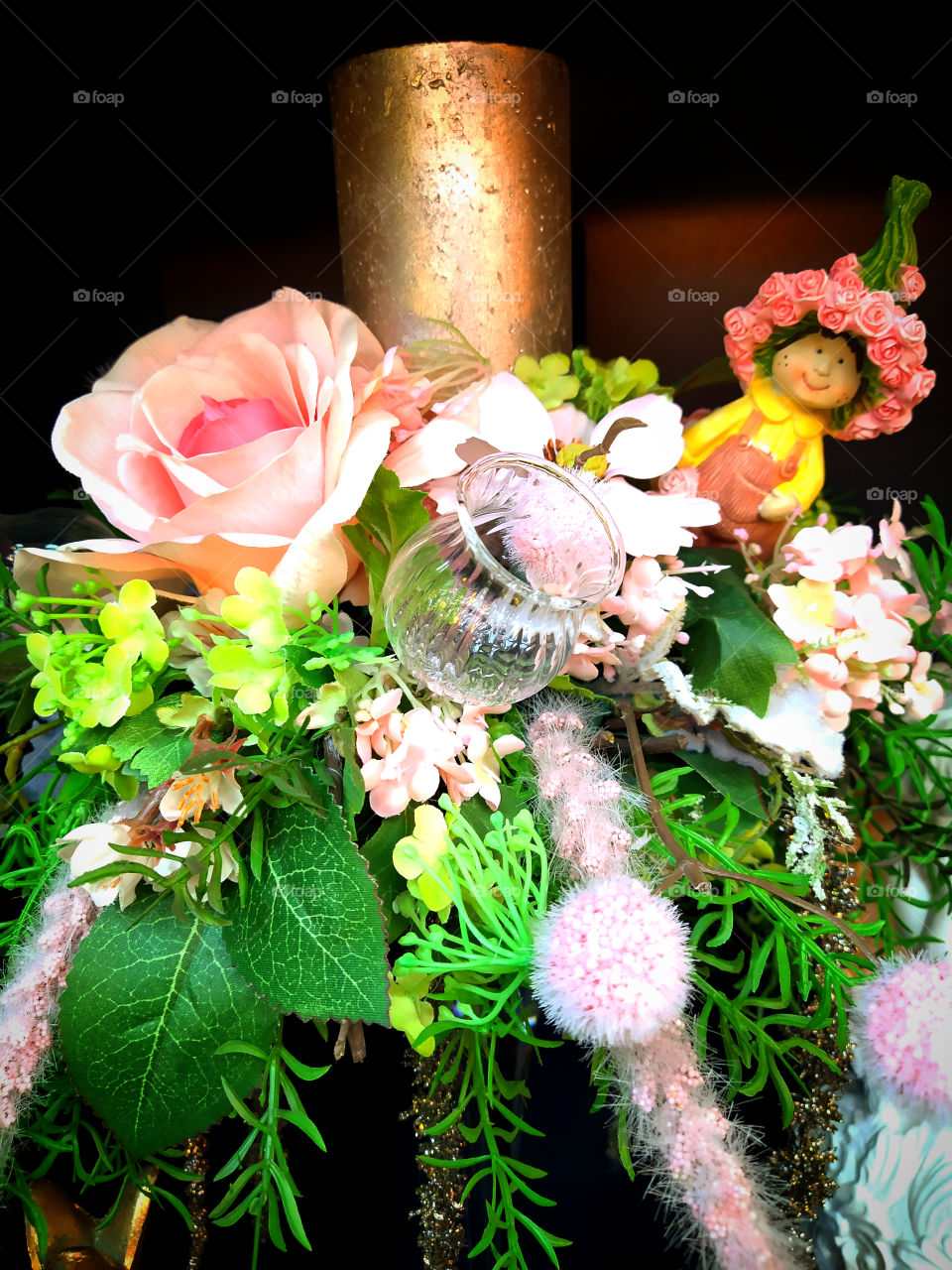 Christmas wreath of flowers, candles and a toy elf