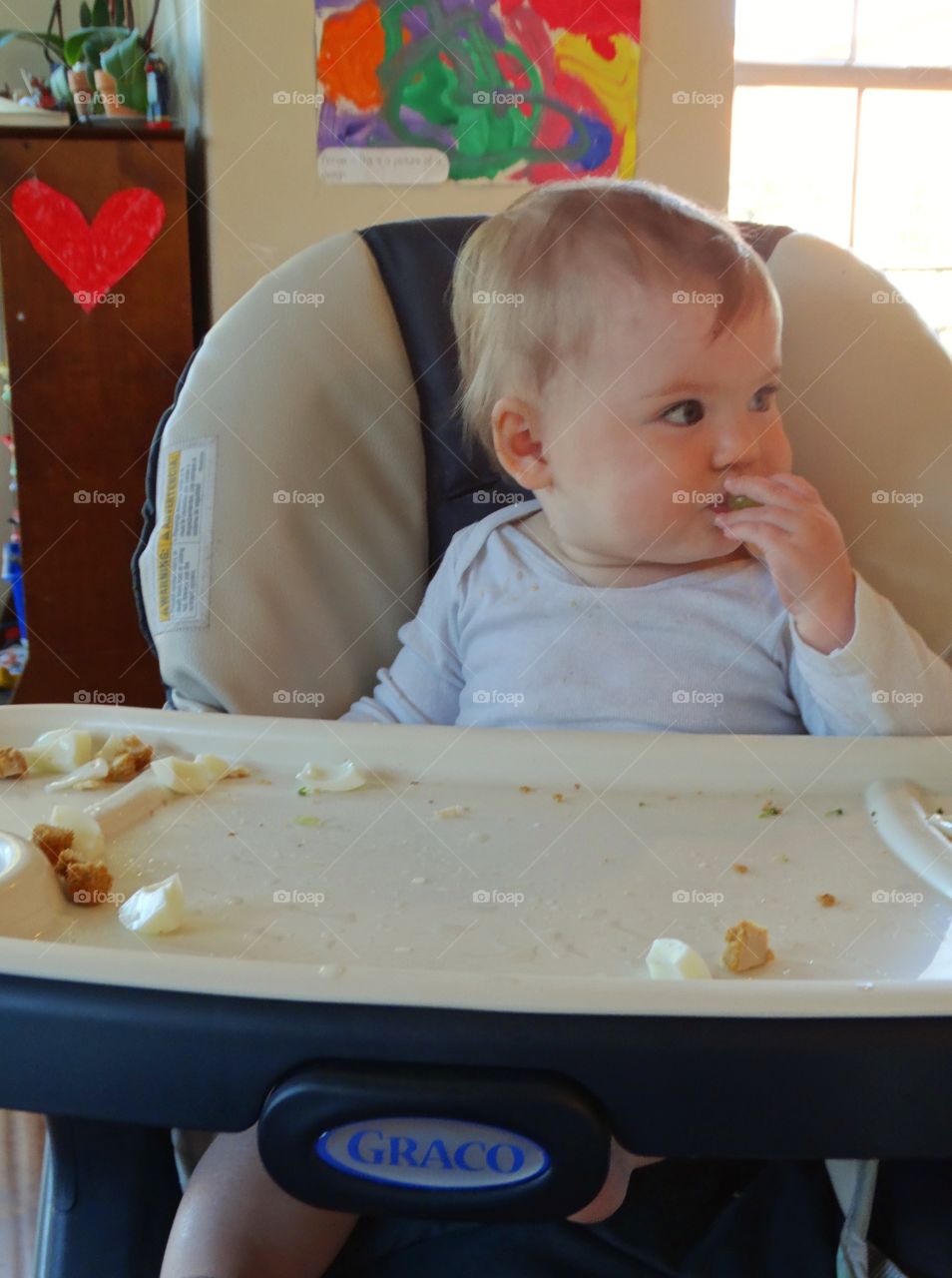 Baby Eating In A Highchair