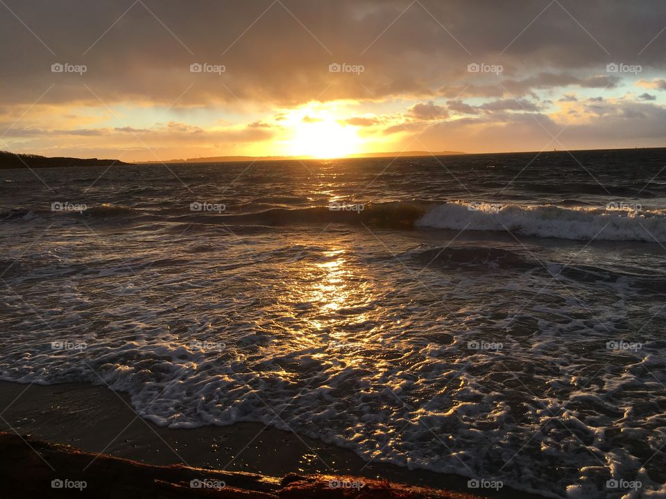 Sunset over wavy sea