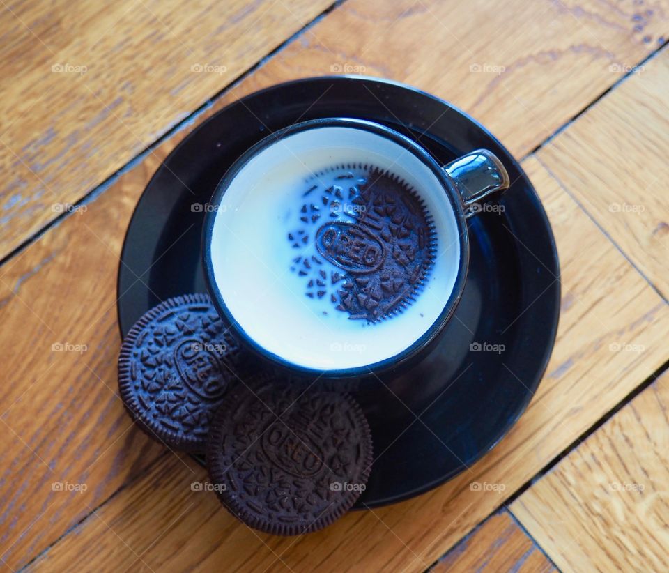 Oreo cookies with cup of milk.