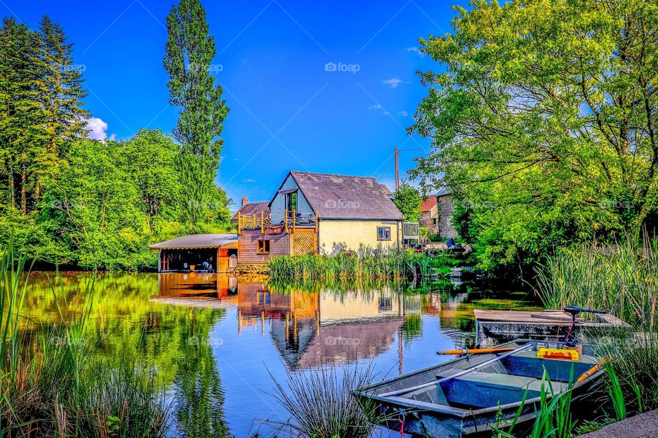 French summer house. Beautiful lake and boat. Reflection.