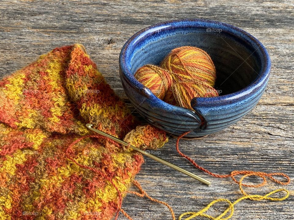 Crocheting a scarf with soft alpaca yarn in a vibrant orange color during this uncertain time!