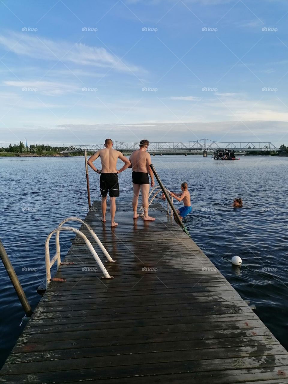 People swimming on a Finnish beach on a warm summer day