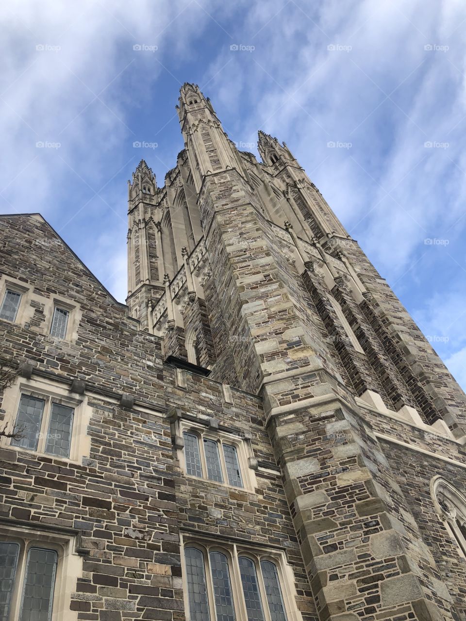The spire of a building at the Princeton University campus looms over the surrounding grassland, striking a feeling of power and greatness into those who see it. 
