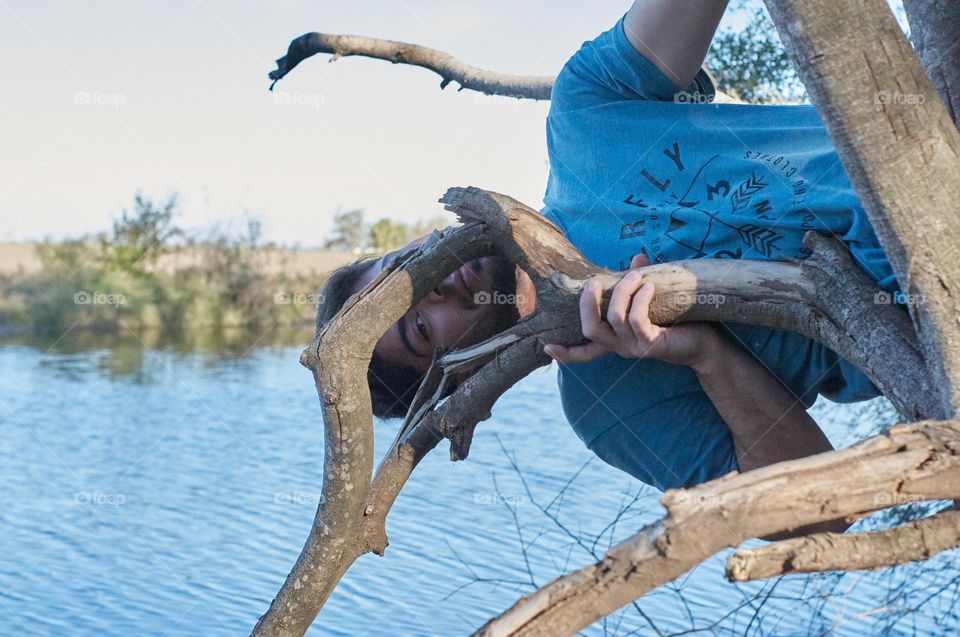 Man looking through a tree in the afternoon