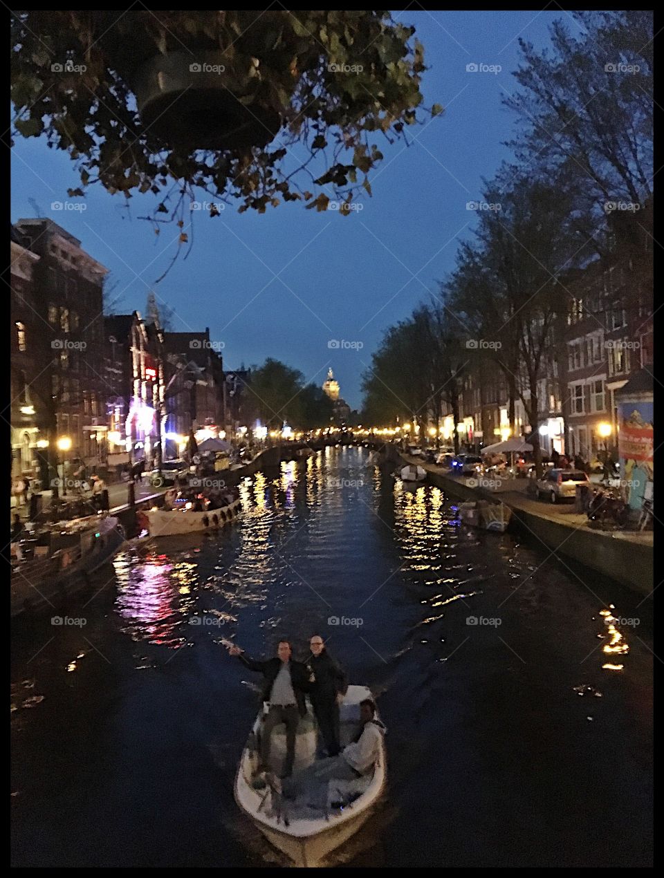 Amsterdam canal. People on boat.