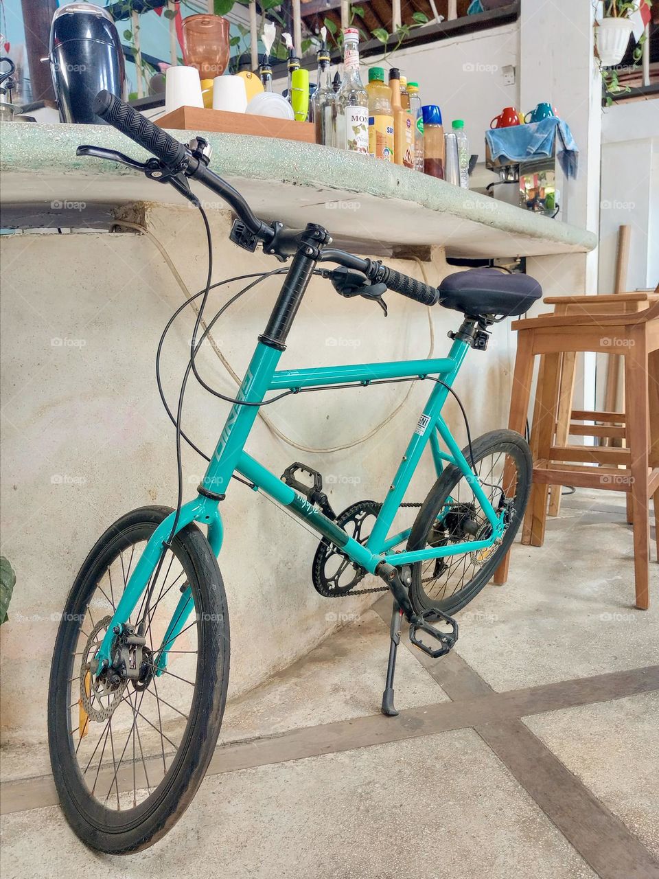 Blue bicycle alone in a bar
