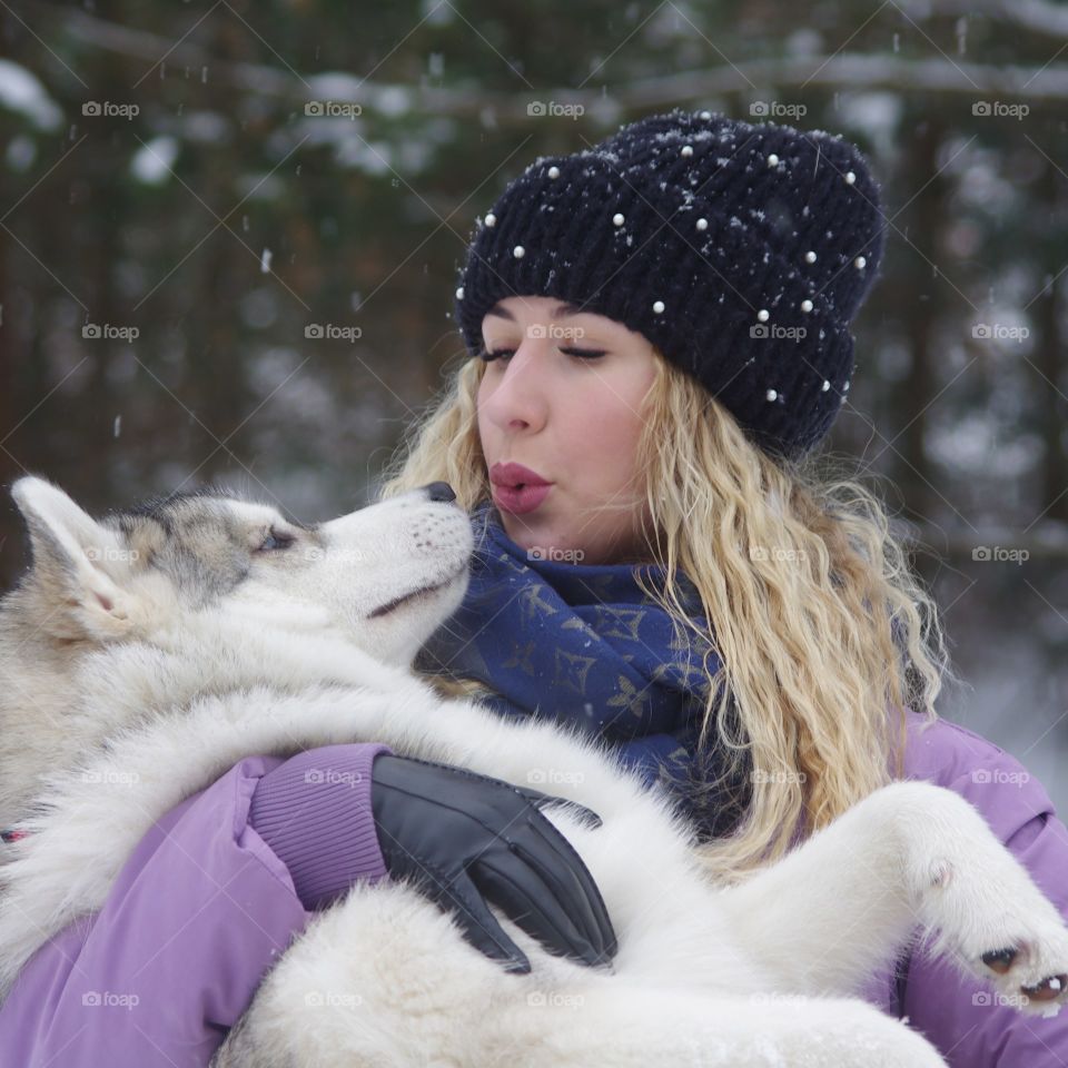 girl holding a dog breed Husky