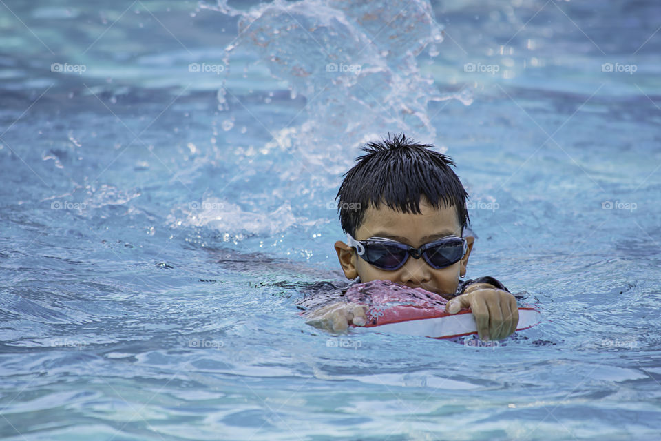 Asean boys are swimming in the pool.