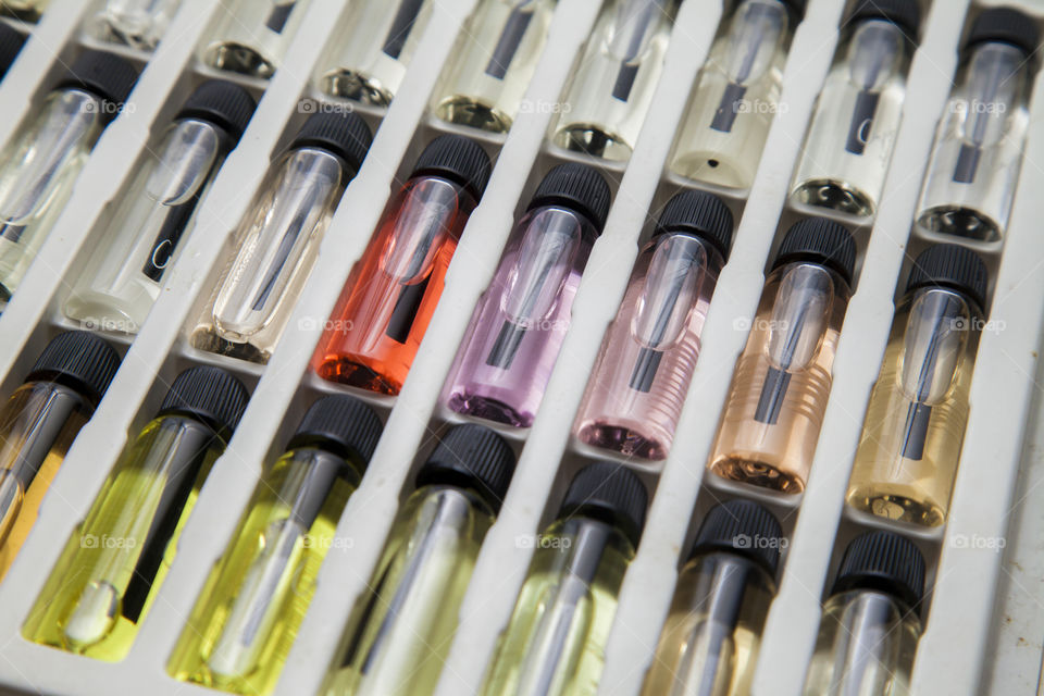 Catalogue with perfume sample bottles, for sale of fragrances of various colors and aromas