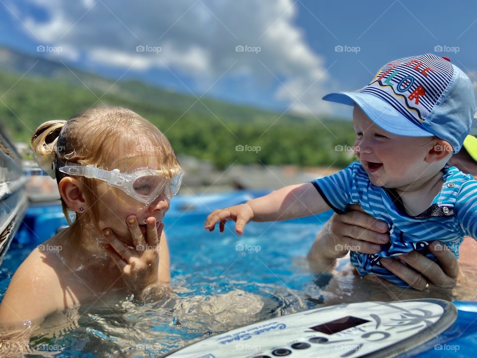 children bathe in a jacuzzi on a sunny hot day
