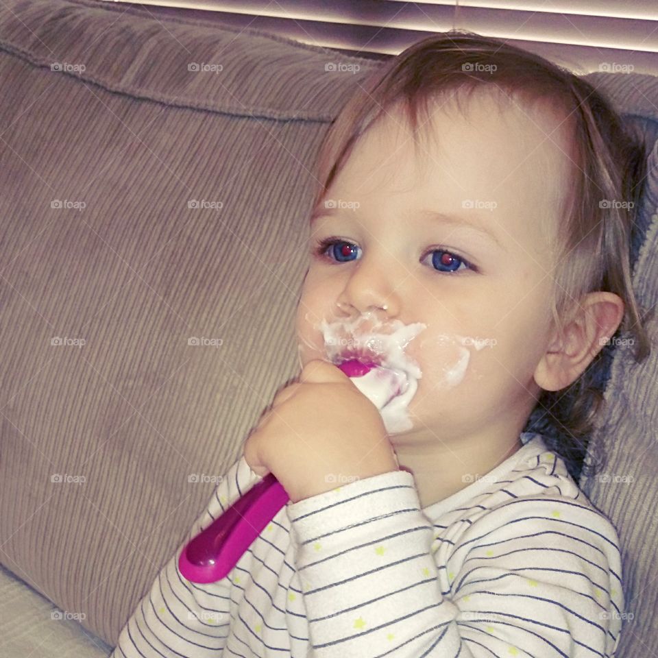 baby eating yoghurt