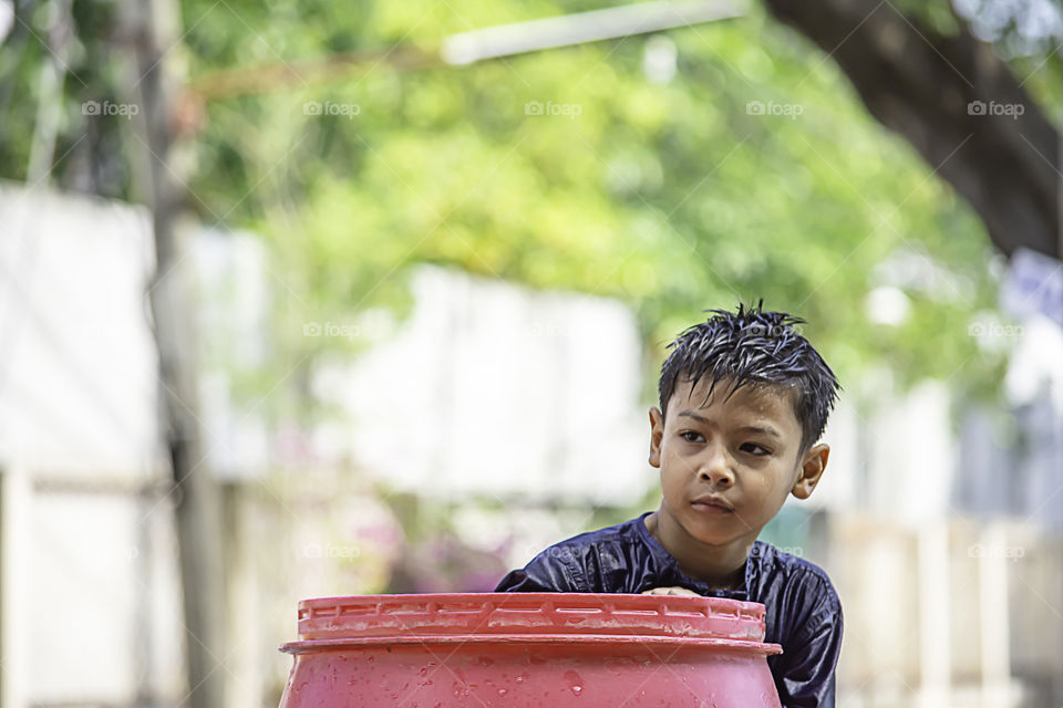 Asian boy play water  in Songkran festival or Thai new year in Thailand.