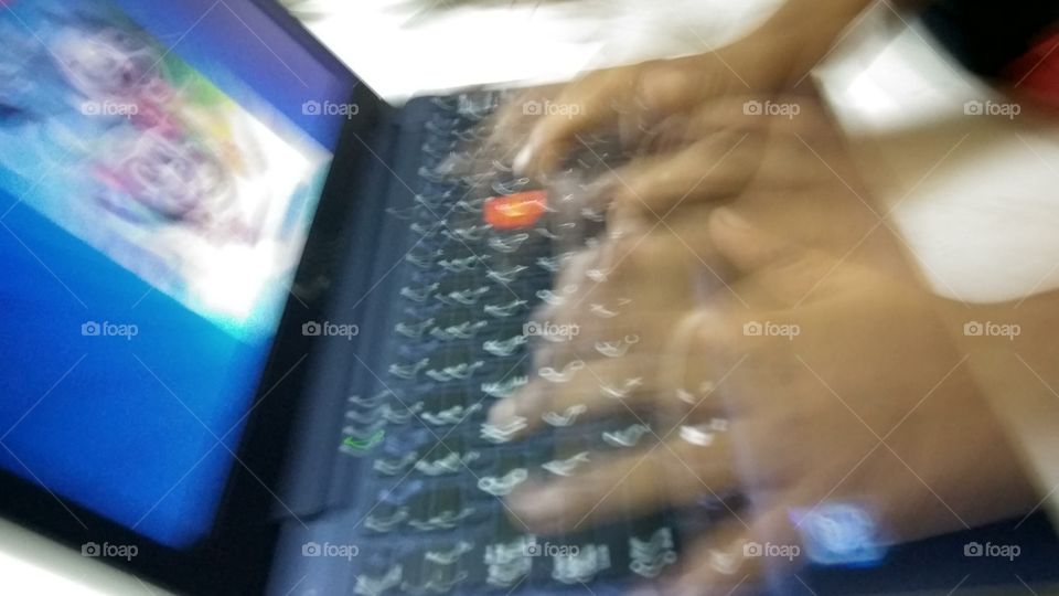 child operating  in laptop typing speed super