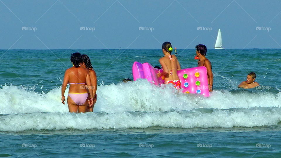 group of people bathing in the sea. summer. holidays. outdoor. sun.