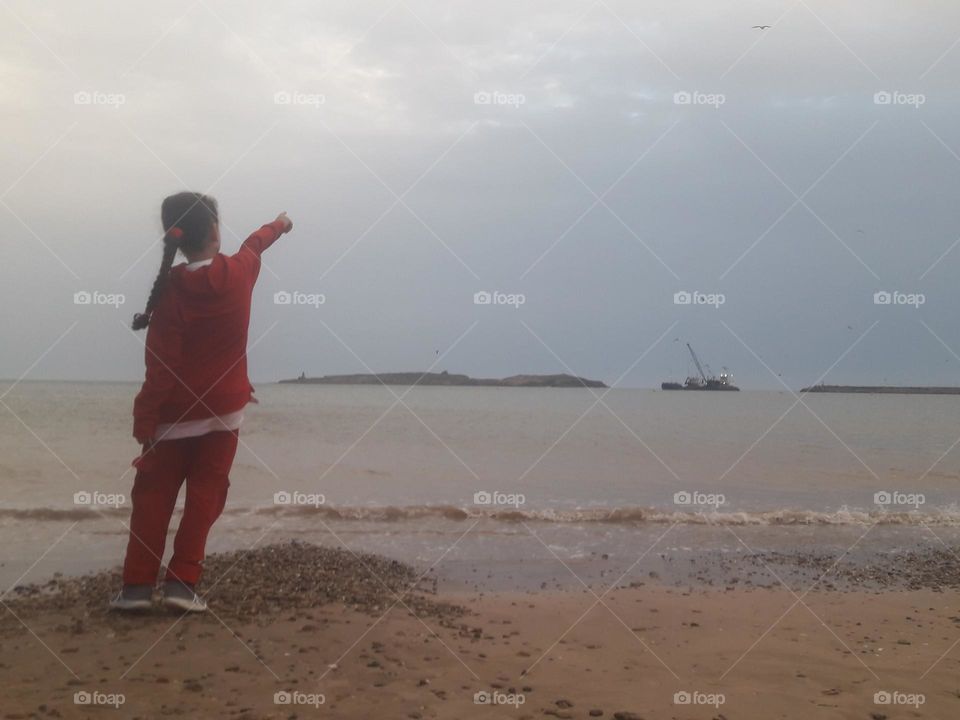 A young woman standing and looking at the iceland.