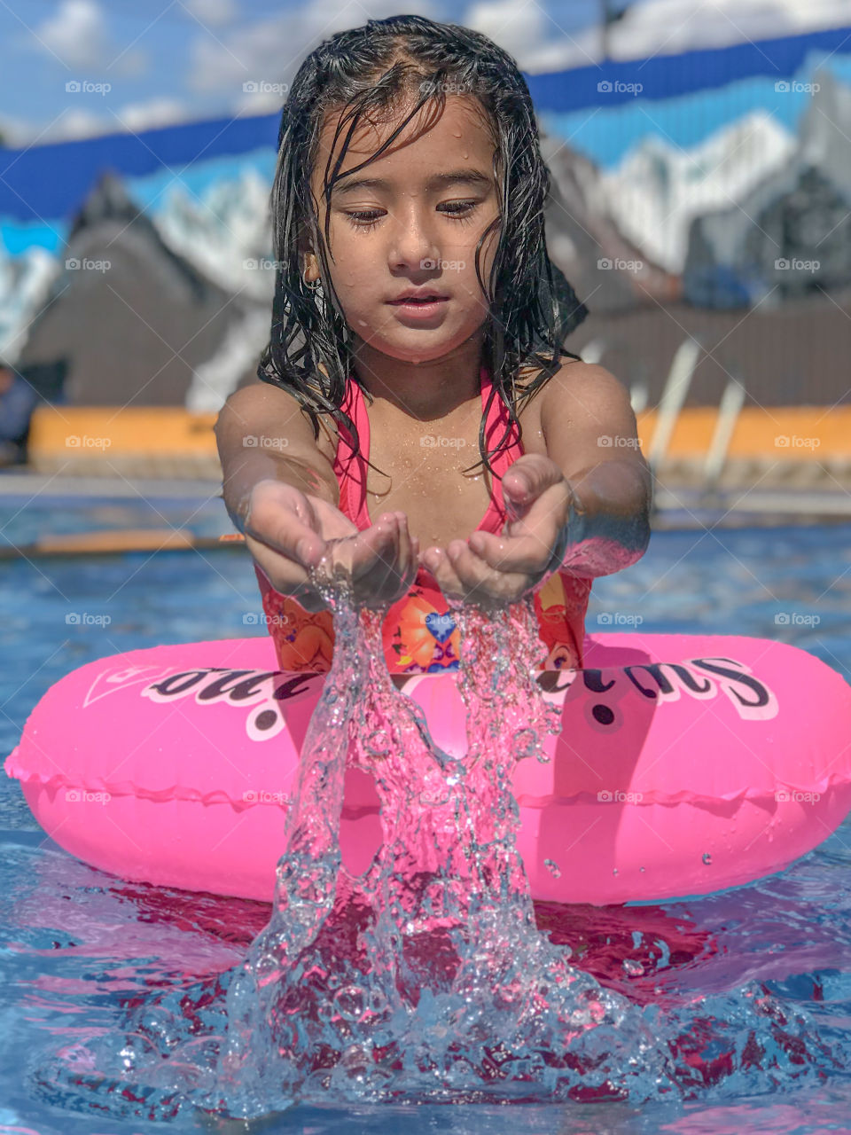 Kid having fun in swimming pool 