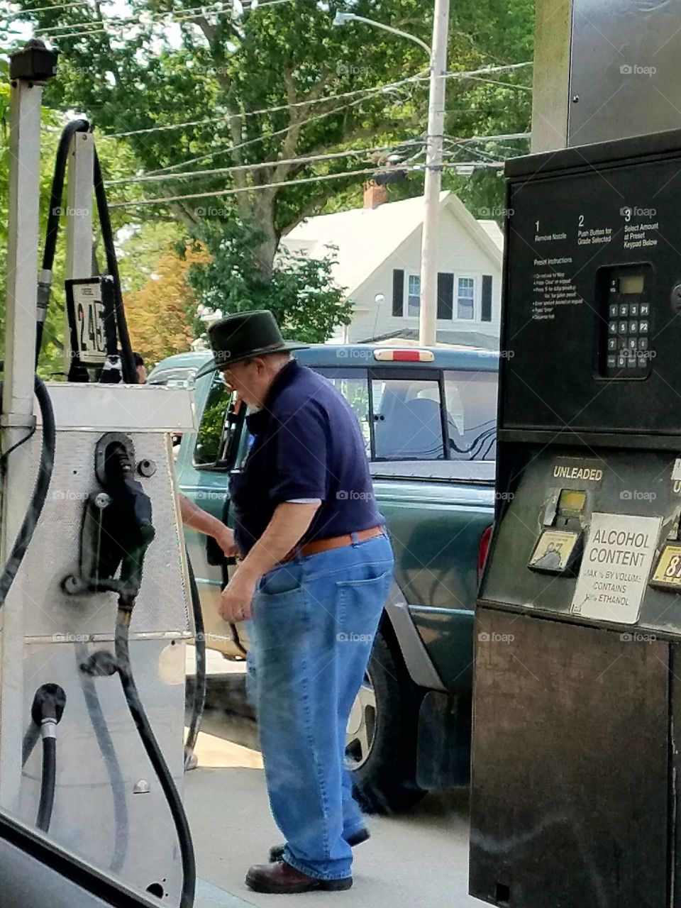 Gas station, man filling his truck.