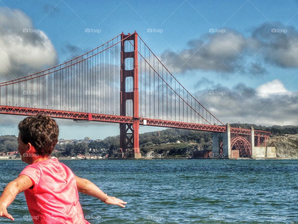 Girl Playing Under Golden Gate Bridge