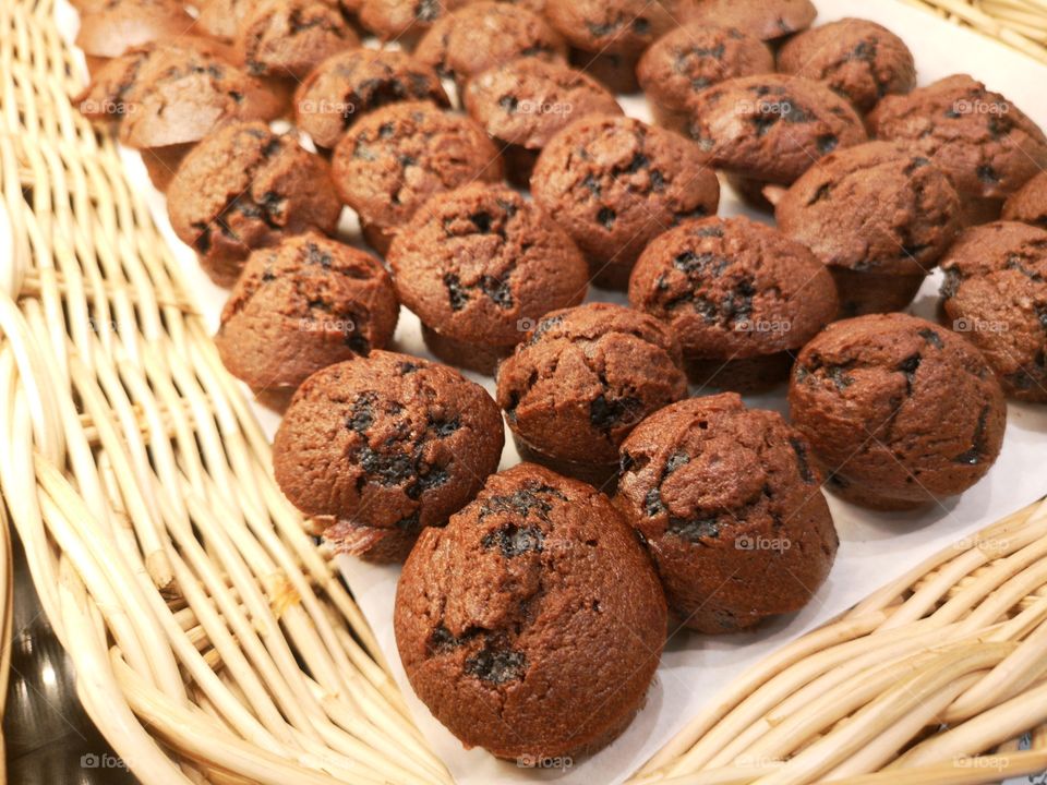 Many chocolate muffins're on the tray.