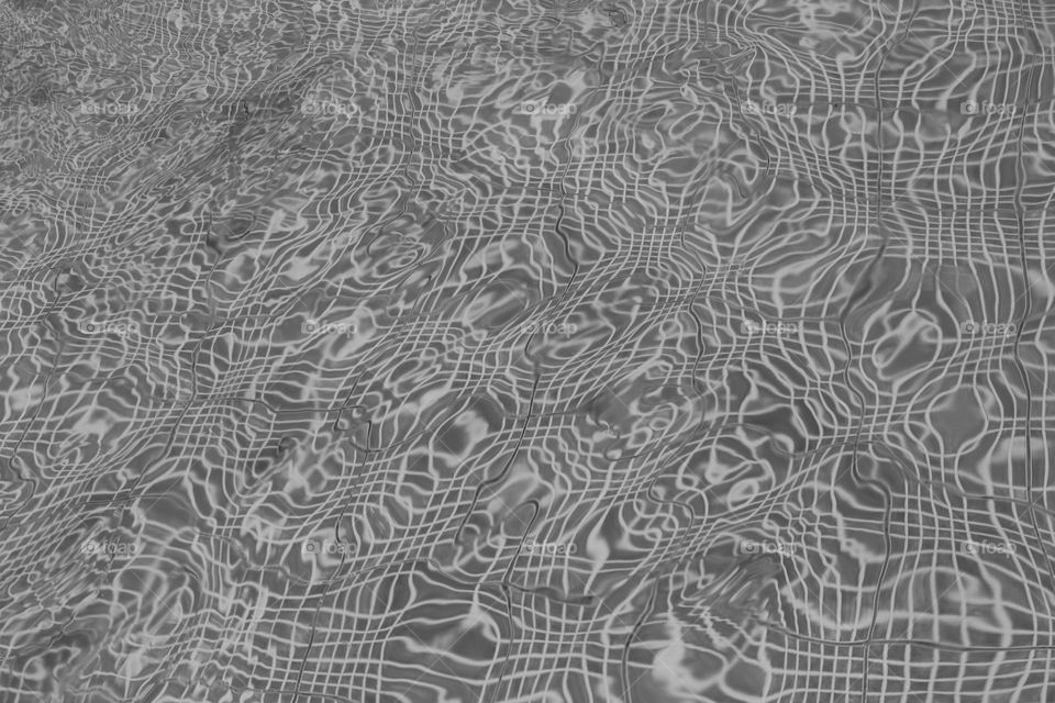 The texture of the wavy surface of the pool.  grey color