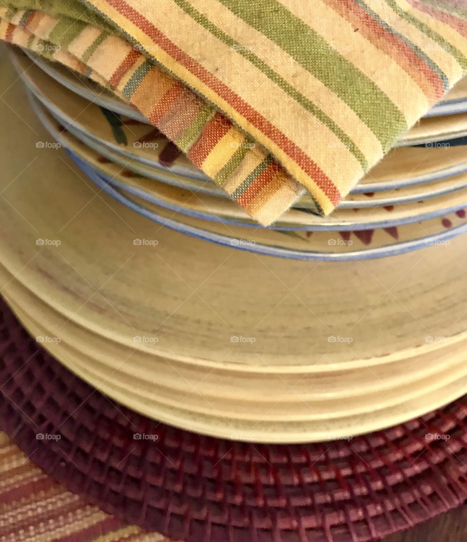 Stack of dishes with kitchen cloth