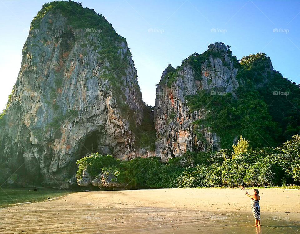 Railay Beach is the name of a beach and a small peninsula located between the city of Krabi and Ao Nang in the Asian country of Thailand. It is accessible only by boat due to the high limestone cliffs of cut access