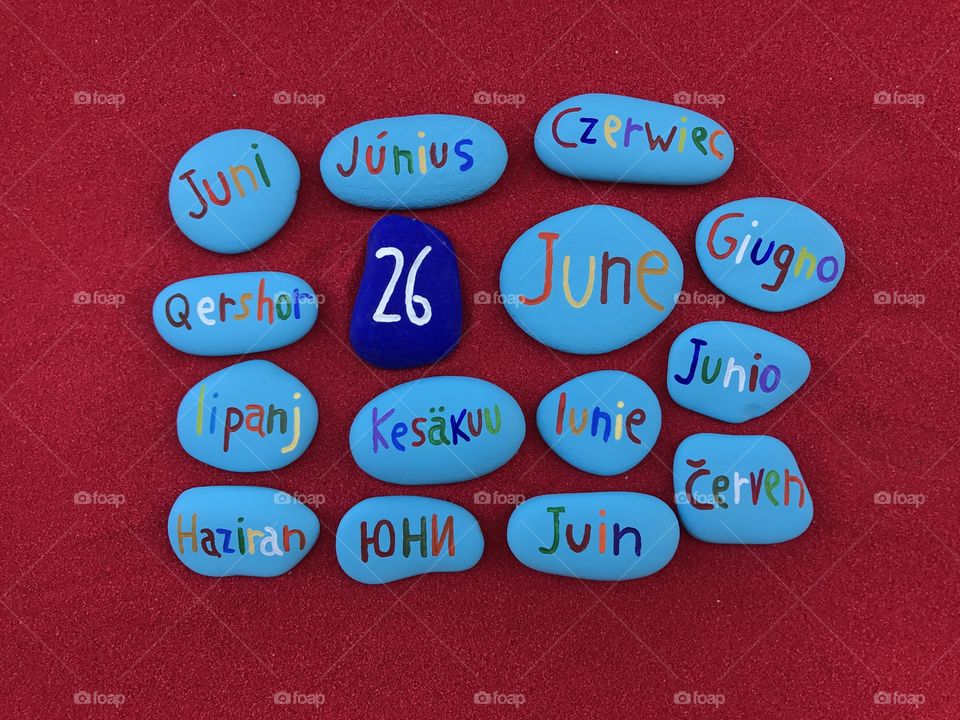 26 June, calendar date in many languages with colored stones and red background 