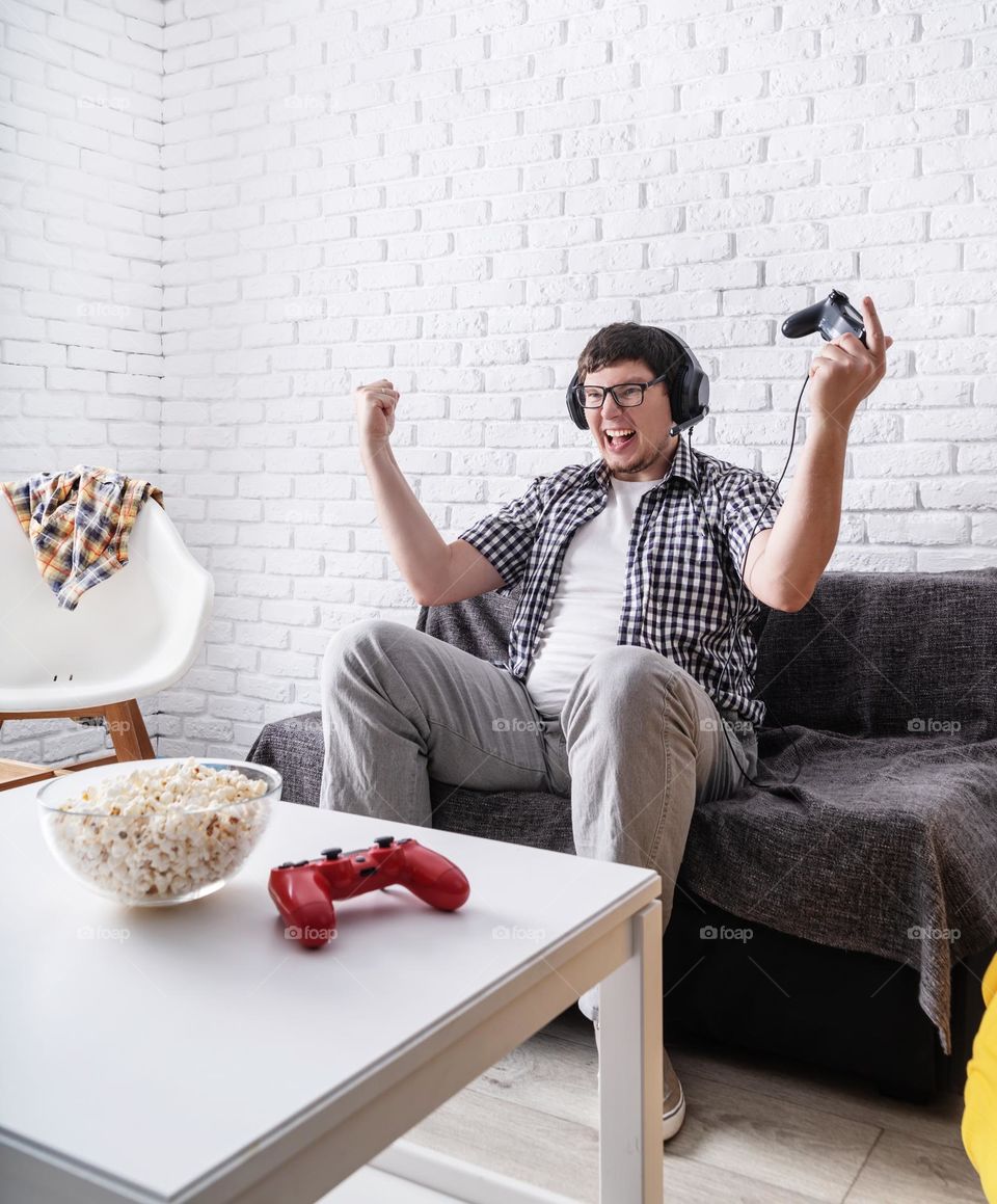 young emotional man playing video games