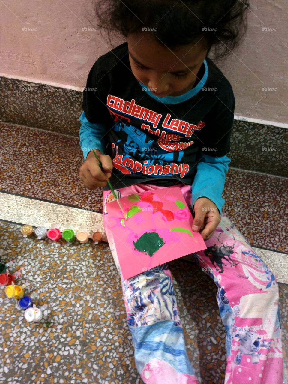 Close-up of girl painting on paper