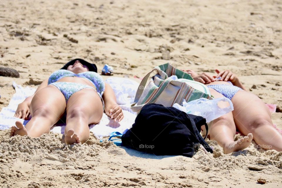 Two girls get a tan on the beach