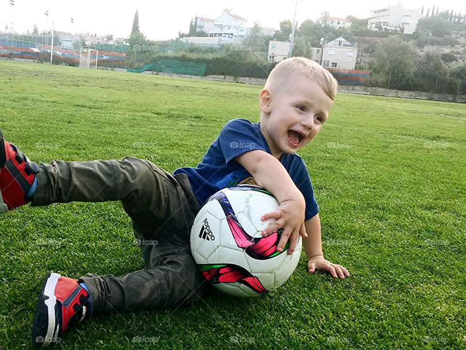 Small child playing with football