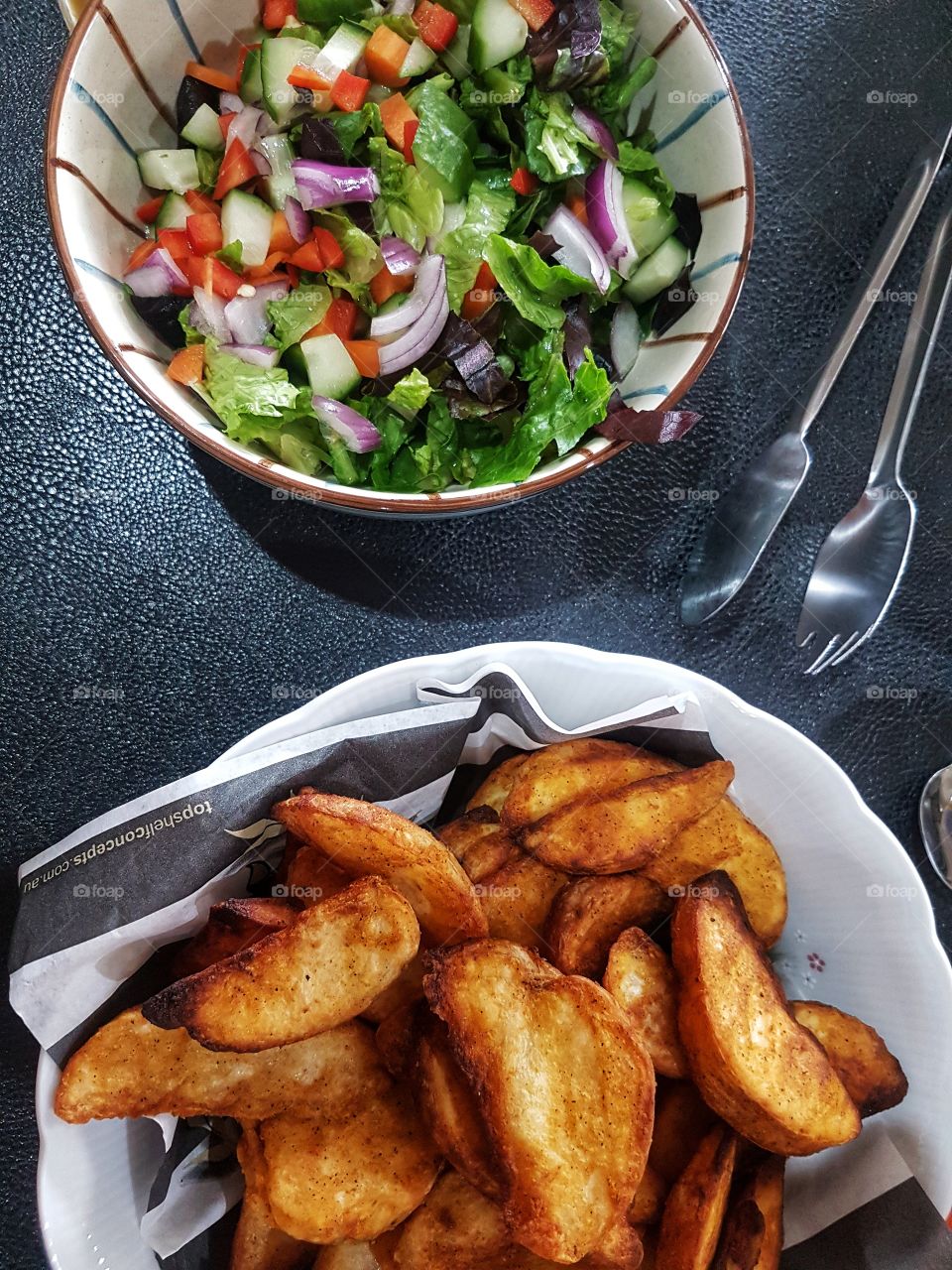 lunch time salad and potatoe wedges on the side