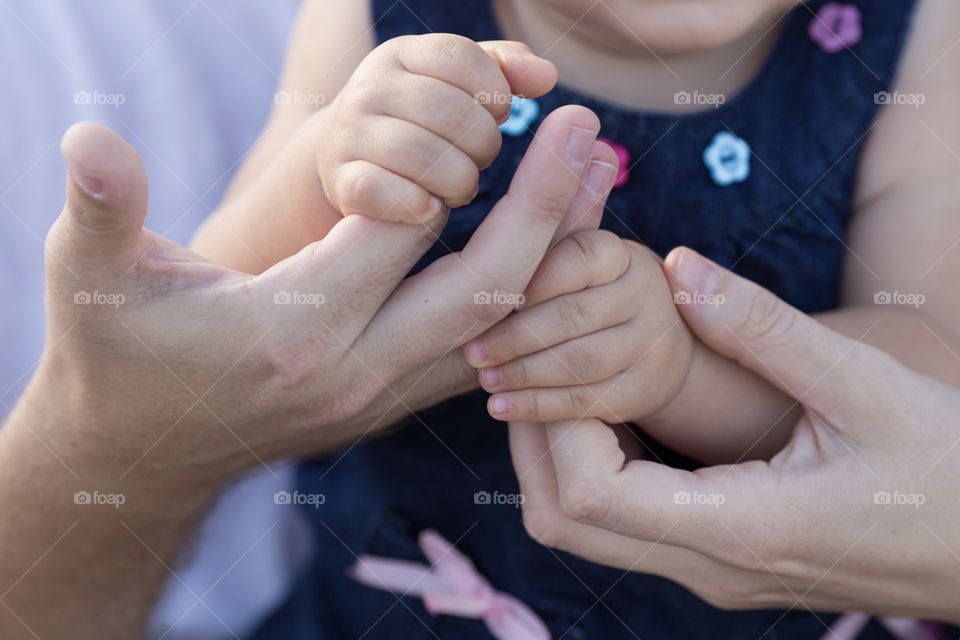 Child handing parents finger closeup 