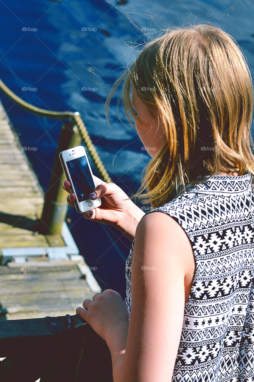 Phonography. Girl uses her phone