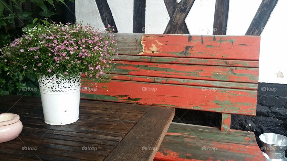 red wooden bench outside front door