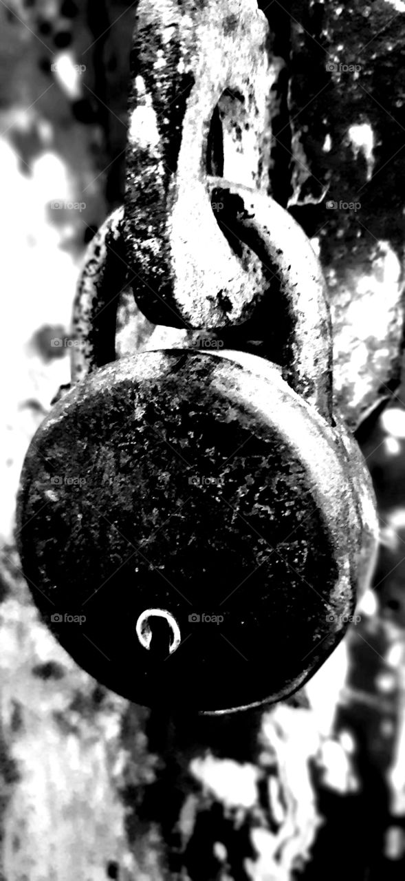 Closeup of an old rusted padlock on adoor in an abandoned building.