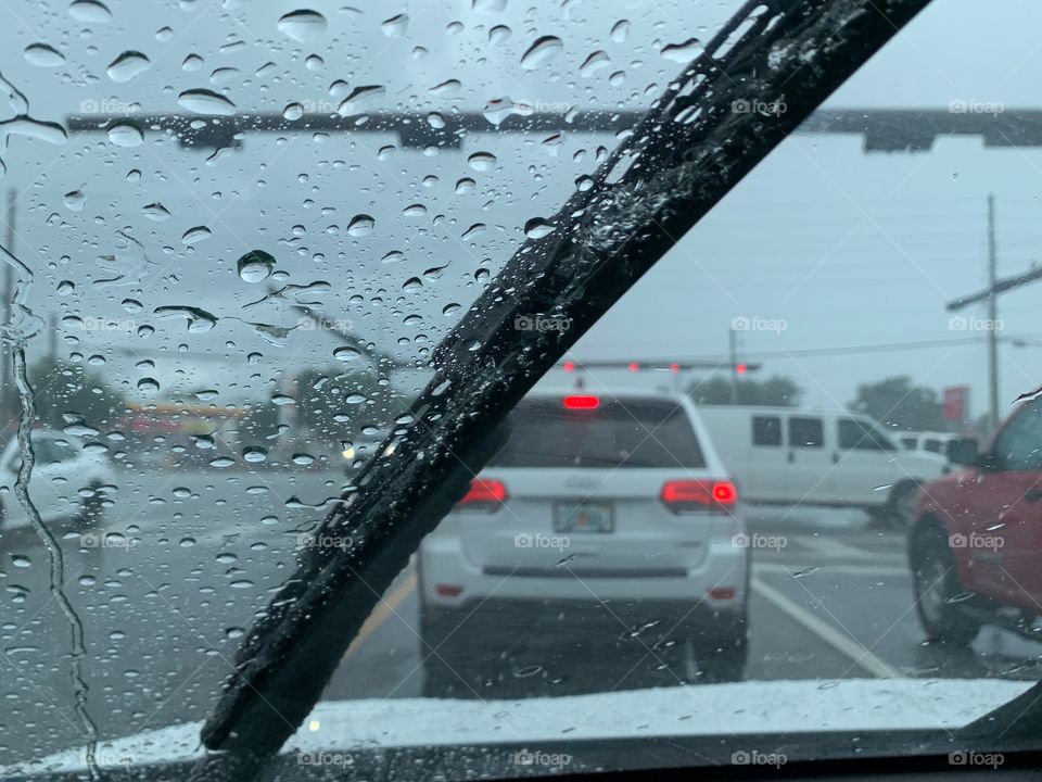 Half and a Half - Windshield wipers in action swiping across the windshield during a rain storm